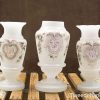 Elegant frosted glass vase trio for vintage decor with intricate pastel designs and charming glow.