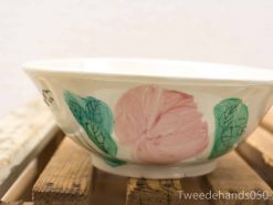 Elegant hand-painted ceramic bowl featuring pastel flowers, perfect for serving or decoration.