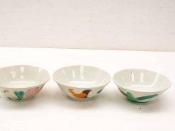 Charming vintage ceramic bowls featuring floral, rooster, and leaf designs for decorative or serving use.