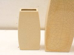 Elegant beige ceramic vases featuring unique crackle texture for modern interior decor.