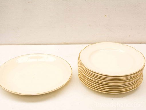 Elegant white plate set with gold rim, perfect for special occasions and stylish dining.