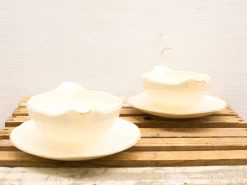 Elegant porcelain bowls on rustic wooden table, perfect for any dining occasion.