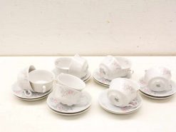 Charming vintage teacups and saucers with pink floral patterns for elegant tea gatherings.