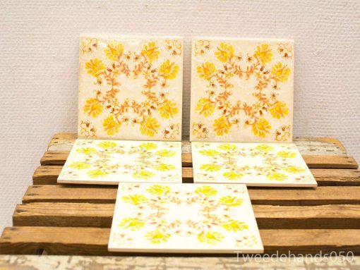 Vintage decorative tiles with floral designs for a warm and inviting home decor.