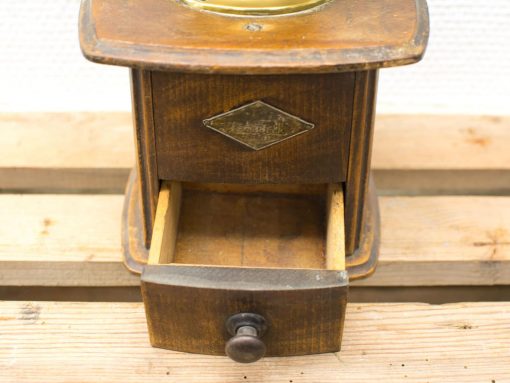 Vintage wooden coffee grinder with brass top, perfect for home decor and coffee enthusiasts.