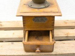 Charming vintage wooden coffee grinder with metal details and nostalgic design for kitchen enthusiasts.