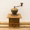Vintage wooden coffee grinder with brass details, showcasing traditional craftsmanship and nostalgic charm.