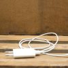 White USB charging cable on rustic wooden background, perfect for Apple devices.