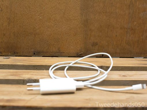 White USB charging cable on rustic wooden background, perfect for Apple devices.
