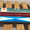 Vintage blue harmonica with a decorative red case, perfect for music lovers and collectors.