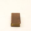 Antique miniature book with leather texture and gold edges, perfect for collectors and decor.