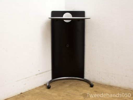 Sleek black side table with a round cut-out, perfect for small spaces and modern design.