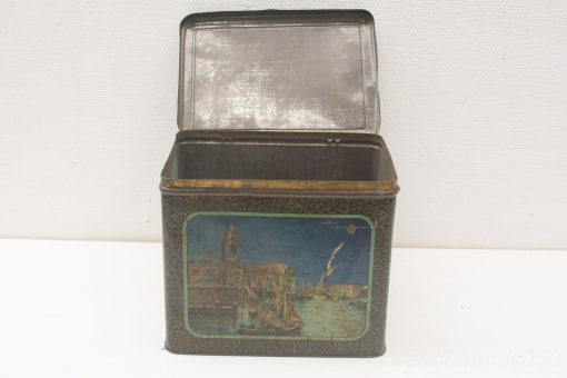 Vintage tin box with charming harbor illustration, perfect for storage or decorative display.