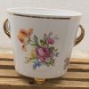 Elegant porcelain planter with floral design and gold accents for stylish home decor.