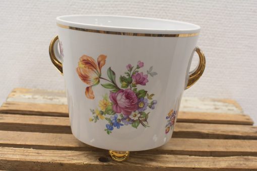 Elegant porcelain planter with floral design and gold accents for stylish home decor.