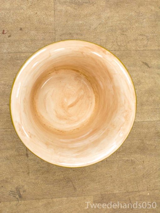 Elegant handmade ceramic bowl with a golden rim, featuring warm peach and off-white hues.