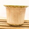 Elegant vintage ceramic flower pot with floral motif and earthy tones, perfect for rustic decor.