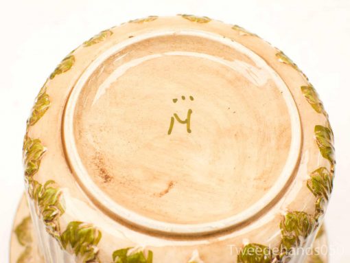 Elegant ceramic pot with green leaf design, perfect for natural decor and plant enthusiasts.