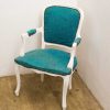 Elegant vintage chair with turquoise upholstery, combining classic charm and modern style.