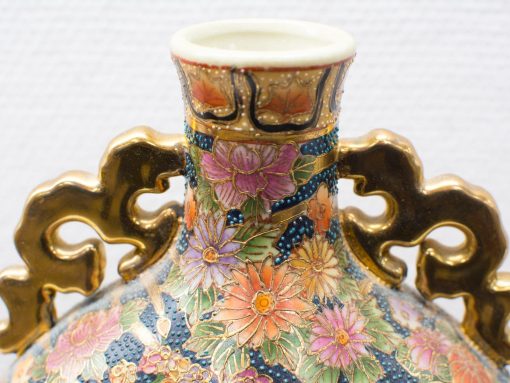 Elegant ceramic vase with intricate floral motifs in vibrant pastels and gold accents.