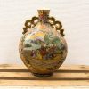 Elegant vintage Chinese vase with intricate designs and vibrant colors in porcelain.