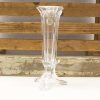 Elegant crystal vase with unique design, ribbed texture, and vintage wooden backdrop. Perfect decor.