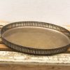Elegant vintage serving tray with decorative perforated border and detailed handles, perfect for all occasions.