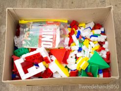 Colorful building blocks and Bingo game components in a well-loved cardboard box.