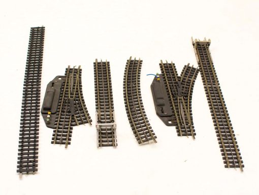 Versatile model railroad track set with straight, curved, and switch components for customization.