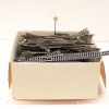 Vintage model train track set in a repurposed box with signal marker included.