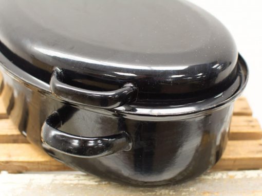 Glossy black cast iron casserole with lid, perfect for cooking and serving hearty meals.