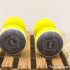 Bright yellow 3kg dumbbells on a rustic wooden surface for effective strength training.