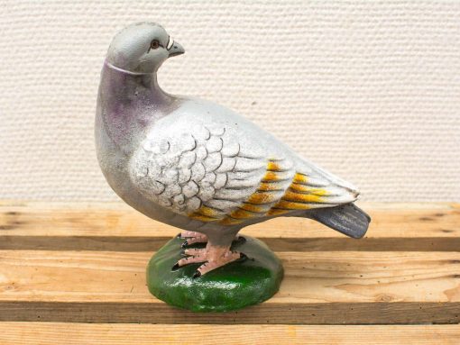 Charming cast iron pigeon sculpture with detailed feathers and vibrant green base, perfect vintage decor.