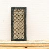 Elegant decorative panel with interlocking circles and floral motifs in a black frame.