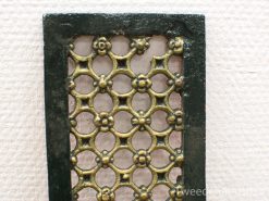 Vintage decorative panel with ornate lattice design, featuring green frame and golden accents.