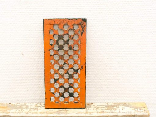 Vintage orange kitchen grater with rustic charm, perfect for adding a nostalgic touch to kitchens.