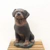 Detailed cast iron Rottweiler sculpture, elegantly seated, perfect for dog lovers and home decor.