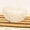 Elegant vintage glass bowl with intricate patterns, ideal for decorative displays or centerpieces.