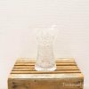 Elegant vintage crystal vase with intricate designs, perfect for decor or floral arrangements.