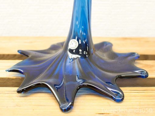 Elegant blue glass sculpture with organic movement, perfect for adding beauty to any space.