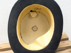 Elegant vintage top hat with beige lining, ribbon bow, and superior craftsmanship label.
