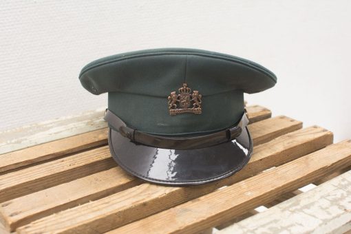 Vintage green military cap with royal insignia, embodying authority and tradition in design.