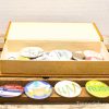 Colorful decorative buttons in an elegant golden box, perfect for personal expression and fashion.