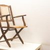 Elegant vintage wooden folding chair with fabric seat, perfect for any setting.