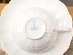 Elegant Kaiser porcelain tea cup and saucer set with intricate design and sophisticated finish.
