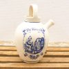 Delft ceramic jug featuring hand-painted monk meditation design, perfect for art and pottery collectors.