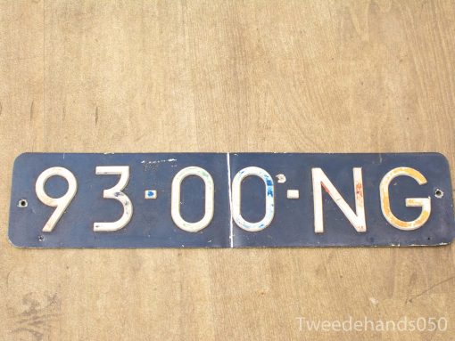 Vintage license plate 93-00-NG on weathered wood, evokes nostalgia and rustic charm.