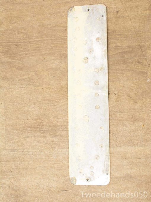 Vintage metal plate with holes, ideal for practical uses or industrial decor.