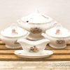 Charming vintage childrens porcelain set with hand-painted whimsical designs for delightful dining.