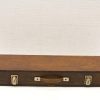 Vintage wooden case with metal corners and handle, perfect for storage and stylish decor.